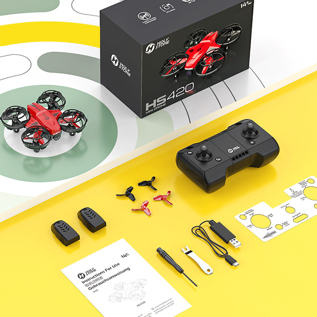 Holy Stone HS420 package contents with remote controller, 2 batteries and accessories